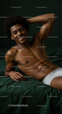 Relaxed young man lying on bed smiling confidently