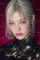 Portrait of a Young Woman with Blonde Hair and Blue Eyes in Black Lace Top