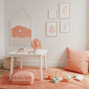 Stylish Children's Room Decor with Peach Cushions and Coral Wall Art