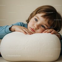 Thoughtful child resting head on large white object