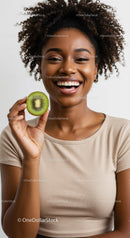 Smiling Woman Holding Kiwi in Bright Studio Portrait