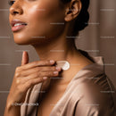 Close-Up of Woman Applying Skincare Cream to Face and Neck