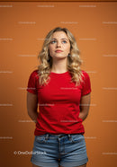 Young woman in red shirt looking thoughtfully upward