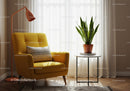 Cozy yellow armchair with houseplant and soft lighting