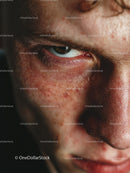Close-Up of Freckled Face with Intense Gaze and Detailed Skin