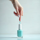 Woman Applying Pastel Blue Nail Polish with Brush