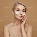 Elegant Mature Woman Applying Face Cream for Skincare Treatment