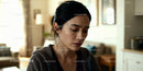Thoughtful woman reflecting quietly at home