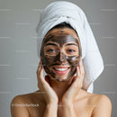 Young Woman Applying Facial Mask with Towel Wrapped Head