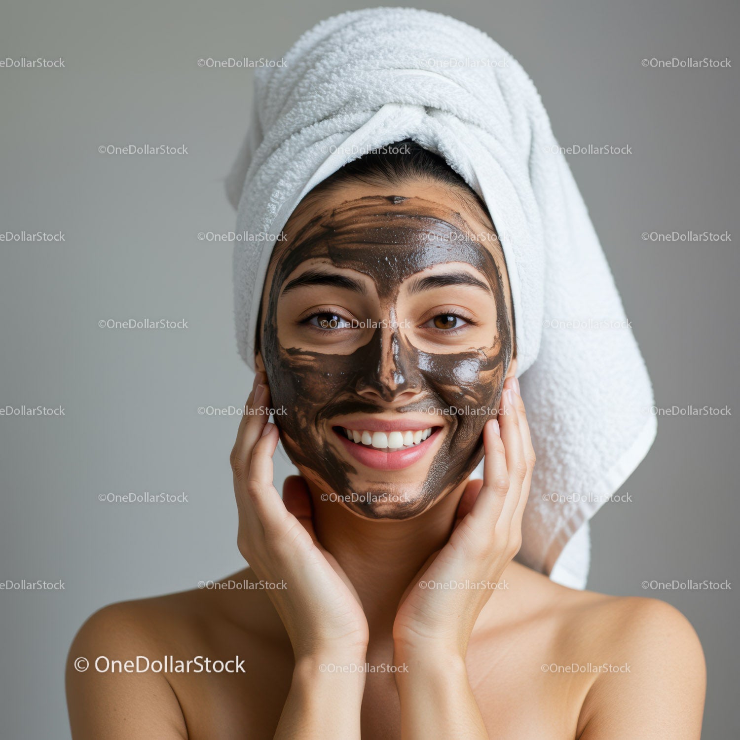 Young Woman Applying Facial Mask with Towel Wrapped Head