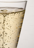 Close up of sparkling golden liquid in clear glass
