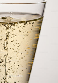 Close up of sparkling golden liquid in clear glass