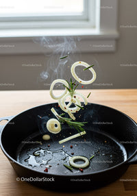 Sizzling Onion Rings and Rosemary in Cast Iron Pan