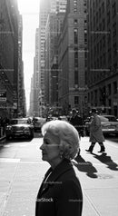 Elderly Woman Walking in Busy Urban City Street
