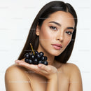 Elegant Young Woman Holding Fresh Black Grapes for Skincare and Beauty