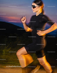 Athlete Running Outdoors at Dusk in Performance Gear