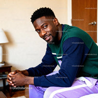 Smiling man relaxing indoors in casual outfit
