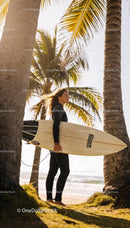 Woman Surfer Standing on Sunny Tropical Beach with Board