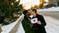 Couple sharing affectionate kiss outdoors on winter street