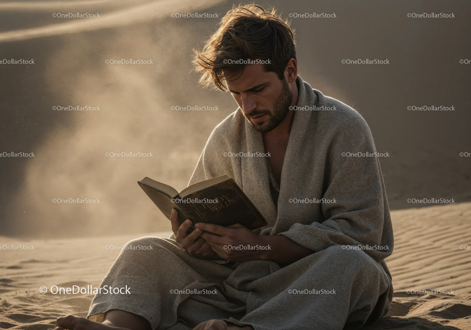Young Man Sitting on Sand Reading Book in Desert Landscape