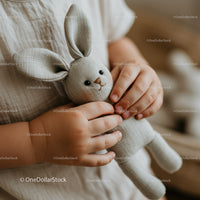 Toddler Holding Soft Fabric Bunny Toy with Care