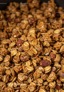 Crunchy granola clusters with roasted nuts close up