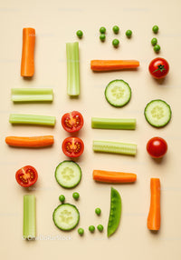 Fresh sliced vegetables arranged on beige surface