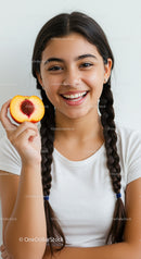 Young Woman with Long Braided Hair Holding Peach with Pit Smile