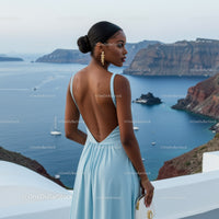 Elegant woman in blue dress overlooking coastal cliffs