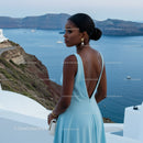Elegant woman in blue dress overlooking sea view