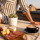Relaxing outdoor moment with coffee and charcuterie board