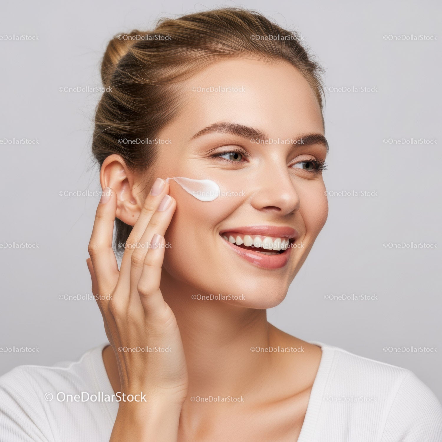 Young Beautiful Woman Applying Moisturizer for Glowing Skin