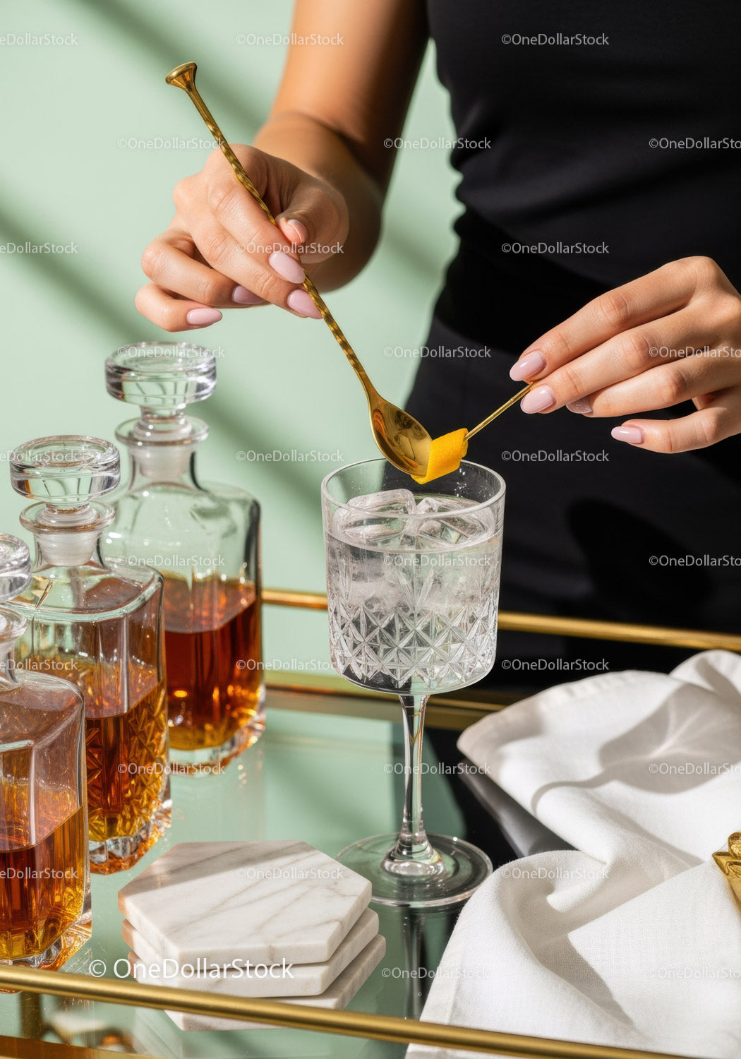 Elegant Cocktail Preparation with Ice in a Crystal Glass