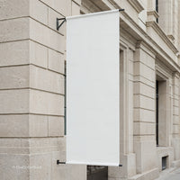 Blank White Banner Hanging on Classic Stone Building