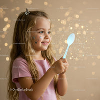 Little girl holding glowing spoon with magical sparkle