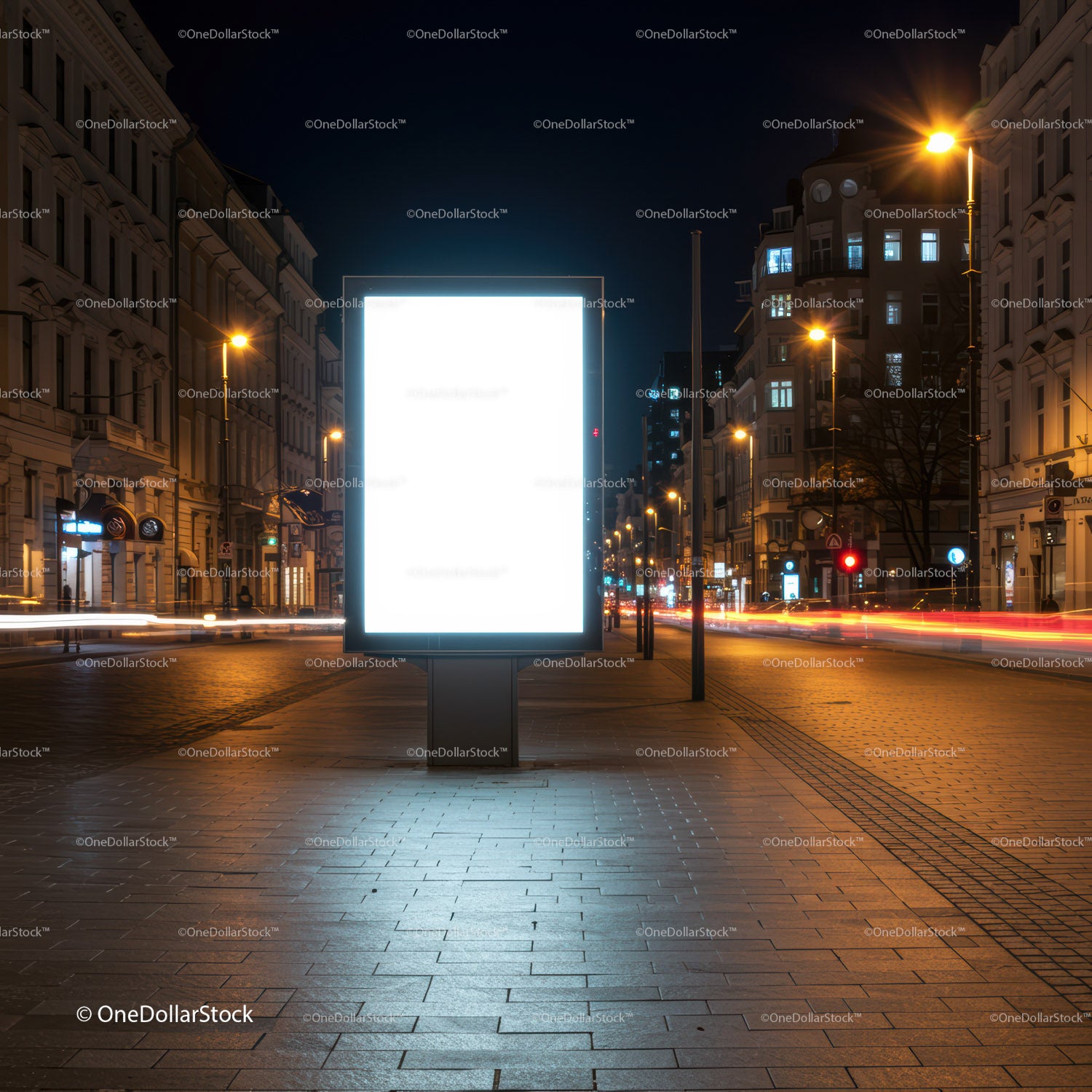 Illuminated blank billboard on city street at night