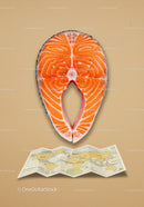 Fresh salmon steak above folded world map on beige
