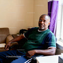 Middle-aged man relaxing at home near window light