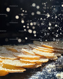 Close-up of Sliced Almonds with Powdered Sugar on Dark Background
