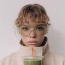 Young Woman in Sunglasses Drinking Green Smoothie in Casual Style