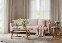 Cozy living room with soft pink sofa and floral decor