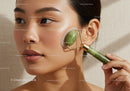 Woman Using Jade Facial Roller for Skin Rejuvenation and Relaxation