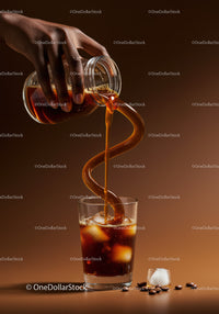 Pouring Iced Coffee Into Glass With Ice Cubes