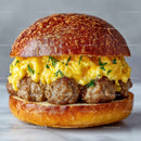 Close-Up of Sausage Patty Egg Scramble Breakfast Sandwich on Toasted Bun