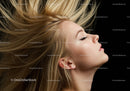Blond woman with flowing hair and closed eyes profile