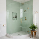 Modern bathroom with glass shower and green tiles