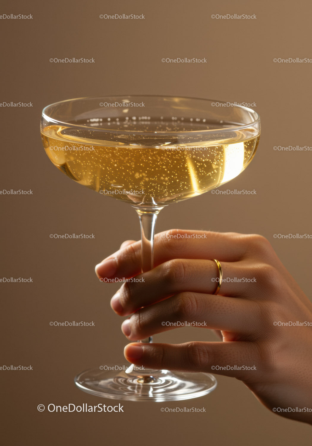 Hand Holding Champagne Glass with Sparkling Bubbles