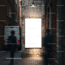 Empty illuminated poster in narrow urban alley at dusk