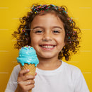 Smiling girl enjoying blue ice cream cone with sprinkles