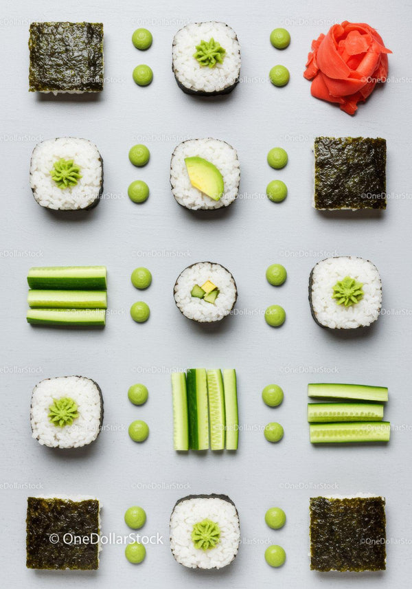 Flat lay of fresh sushi rolls and cucumber slices